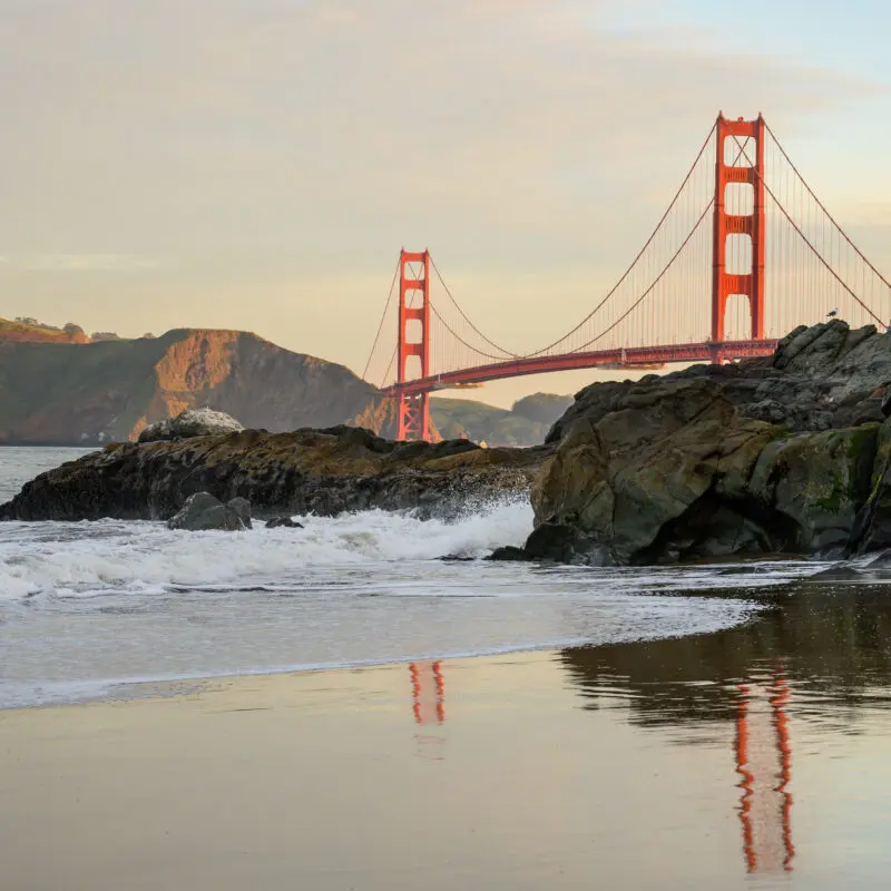 Golden Gate Reflects in Baker Beach Surf on quiet morning