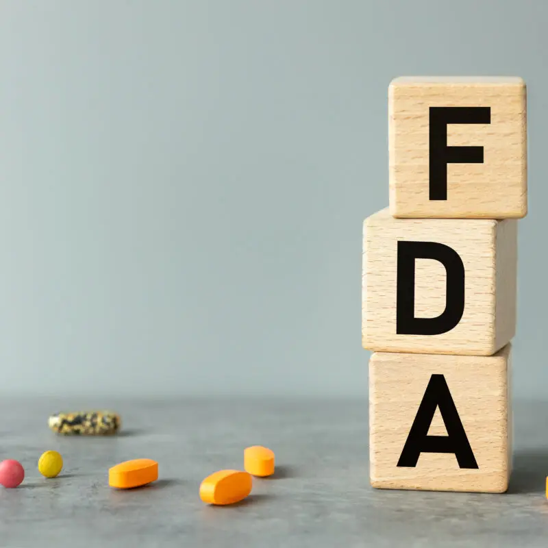 FDA, words on wooden blocks. Beautiful gray background, business concept, Confirmation of inspection and registration of drugs and medical devices used in medicine, copy space