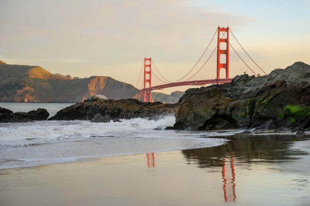 Golden Gate Reflects in Baker Beach Surf on quiet morning