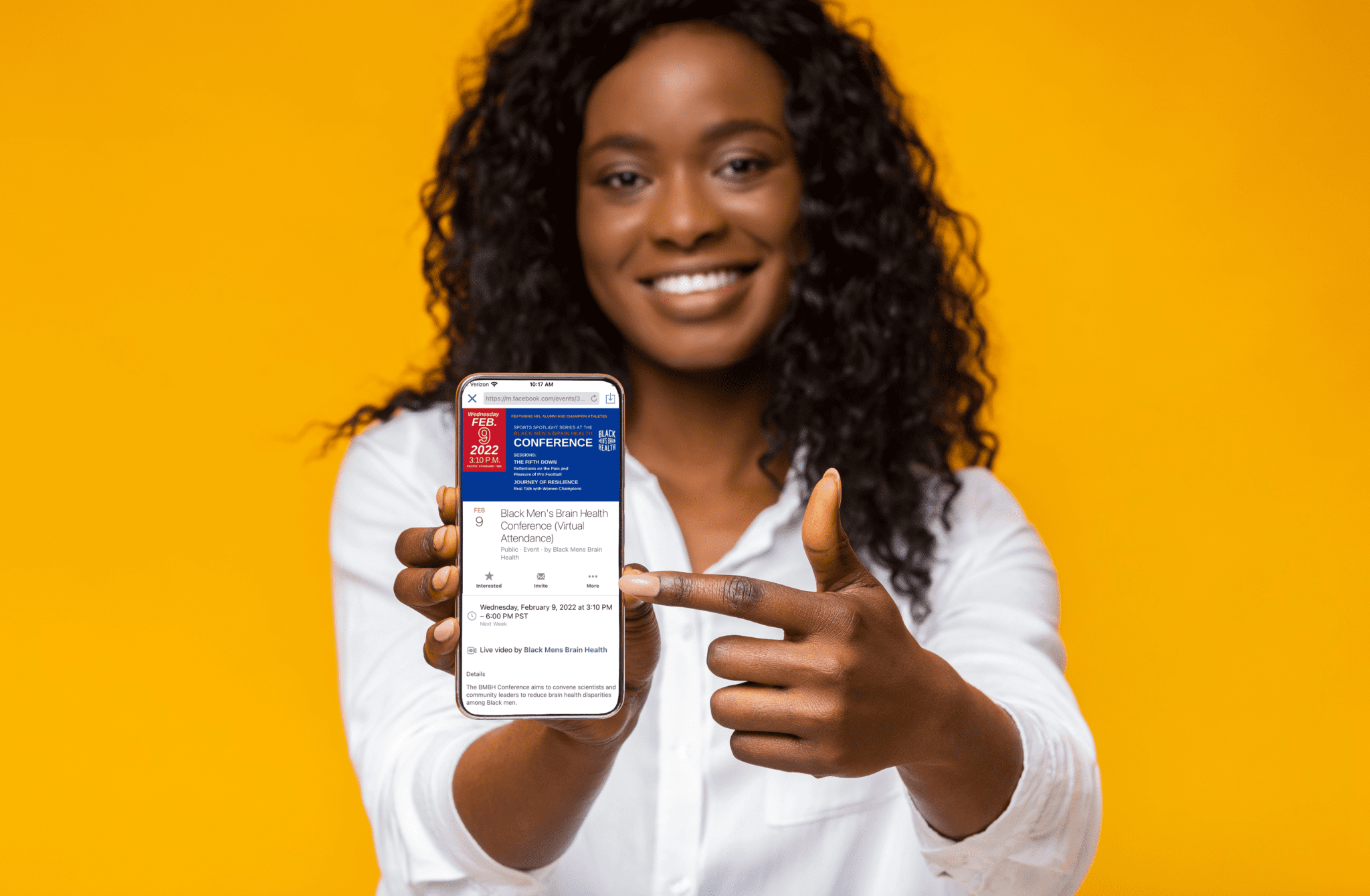 african american woman pointing to phone